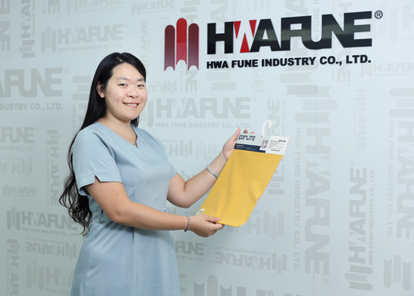 Hwafune team member presenting Porlite fabric sample at company showroom