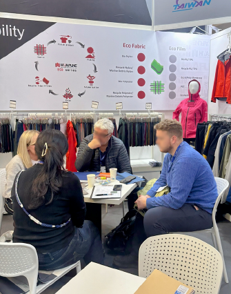 Hwafune team holding meetings with visitors at an international textile trade show